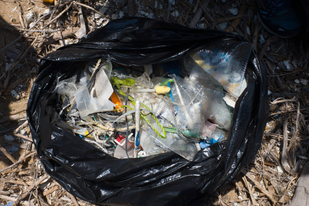 Contents of a refuse sack show plastic items collected by participants taking part in a beach clean-up on Hong Kong's outlying Lamma island on May 27, 2018. - More than two thousand volunteers hit the beach on an outlying island of Hong Kong for a mass rubbish clean-up on May 27 as environment campaigners warned plastic is killing sea turtles and other wildlife. (Photo by Anthony WALLACE / AFP)