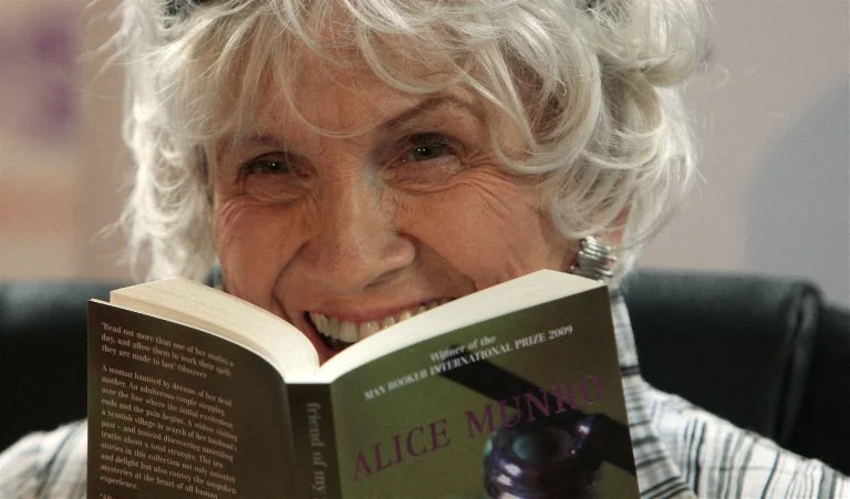 Canadian author Alice Munro holds one of her books as she receives her Man Booker International award at Trinity College Dublin, in Dublin, Ireland, on June 25, 2009. Canadian short story writer Alice Munro has won this year's Man Booker International Prize worth 60,000 pounds (95,000 US dollars, 70,000 euros).  It is awarded every two years, and since its creation in 2005 has been given to Albania's Ismail Kadare and Nigeria's Chinua Achebe. The panel, which comprised writers Jane Smiley, Amit Chaudhuri and Andrey Kurkov, praised the 77-year-old for the originality and depth of her work. AFP PHOTO/ Peter Muhly (Photo by PETER MUHLY / AFP)