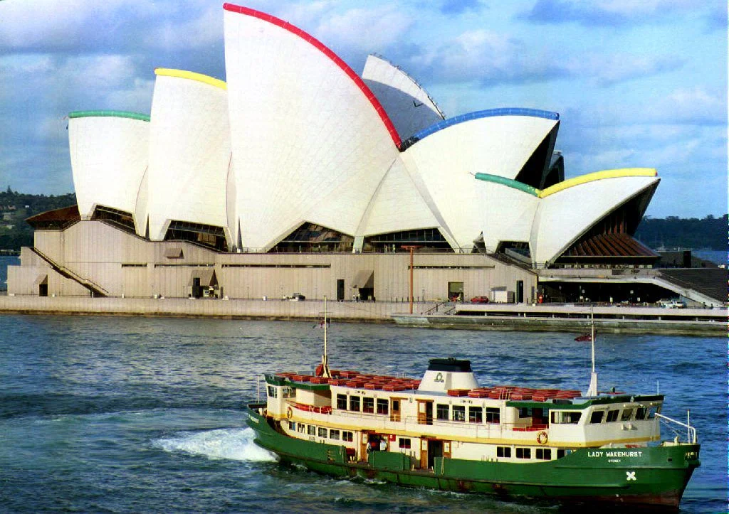 The sails of the Opera House are edged with huge coloured neon tubes illuminated by 250 lights which echo the Sydney 2000 Olympic logo 23 September 1993. The light show will be the backdrop for the "Cheers Or Tears" party on the shores of Sydney Harbor. The International Olympic Committee will announce 23 September 1993 in Monaco its choice for the host-city of the 2000 Olympics. (Photo by TORSTEN BLACKWOOD / AFP)